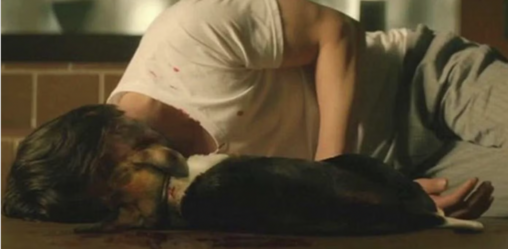 Screenshot of John Wick on the floor next to his lifeless dog.